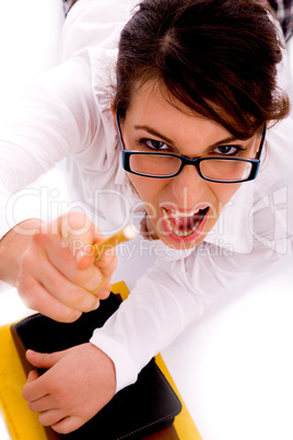 high angle view of shouting female pointing with pencil