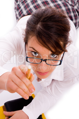 high angle view of female student pointing with pencil