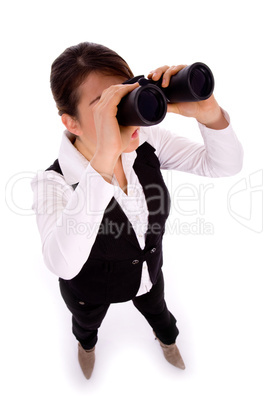 full body pose of businesswoman viewing through binoculars