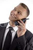 handsome young businessman smiling and talking on phone