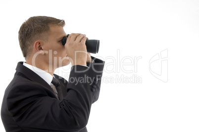 handsome young businessman using a pair of binoculars