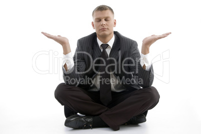 handsome young businessman doing yoga with open palms