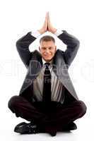 handsome young businessman performing yoga
