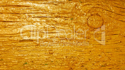 Wooden plank painted in golden