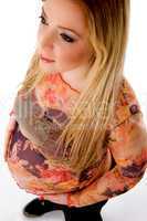 top view of pregnant model holding her tummy