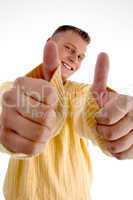 smiling man showing good luck sign with both hands