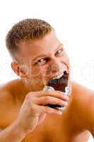 muscular man eating chocolate