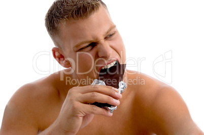 muscular guy eating chocolate