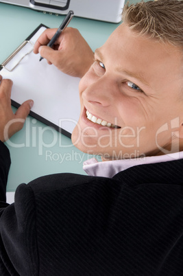 back pose of smiling employee with pen and writing board