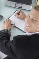 back pose of smiling ceo with pen and writing board