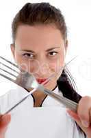 close up of female chef holding cutlery