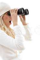 side view of amazed woman looking through binoculars