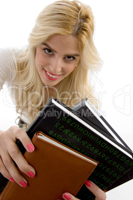 front view of smiling student holding course books