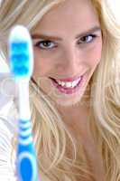 front view of smiling woman holding toothbrush