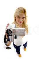 high angle view of smiling model with camcorder