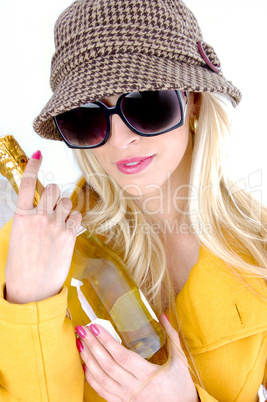 front view of fashionable woman holding wine bottle