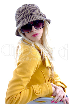 side view of model with cap and sunglasses