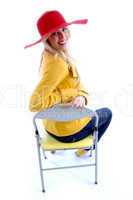 side view of smiling woman sitting on chair