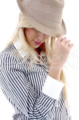 side view of young female holding hat