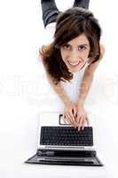 laying woman working on laptop