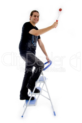 young painter standing on ladder chair
