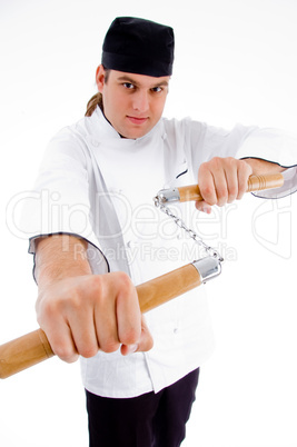 chef holding nunchaku in fighting stance