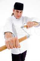 chef holding nunchaku in fighting stance