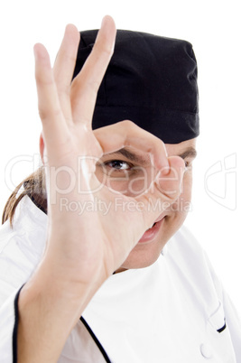 chef looking through finger hole