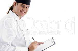 smiling young male chef with clipboard