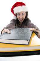 beautiful student in christmas hat with study material