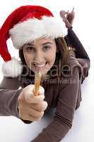 young student in christmas hat showing her pencil