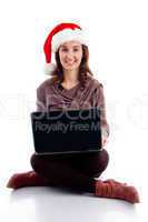 cheerful young woman in christmas hat posing with laptop