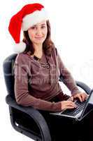woman in christmas hat busy with laptop