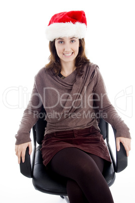 female in christmas hat resting on chair