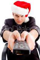 man holding remote control and wearing christmas hat