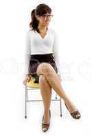 full body view of woman sitting on chair
