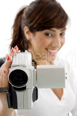 front view of smiling female shooting with handy cam