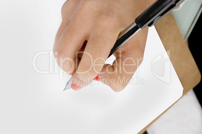 high angle view of female hand writing on document