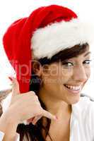 front view of cheerful female executive in christmas hat with phone call hand gesture