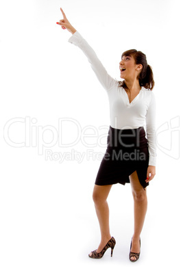 front view of smiling businesswoman pointing up