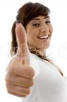 side view of smiling female attorney with thumbs up