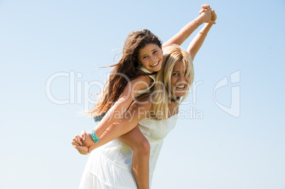 Pretty woman playing with young girl