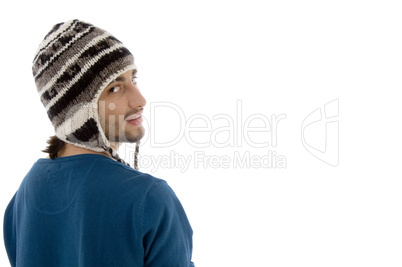 man looking aside and wearing woolen cap