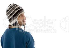 man looking aside and wearing woolen cap