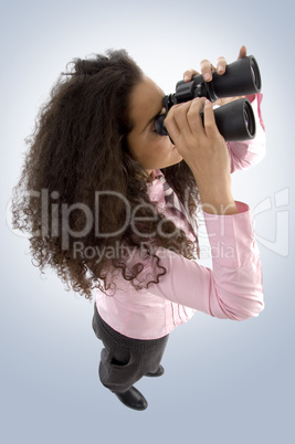 young pretty woman watching with binoculars