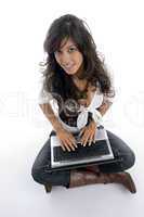 female operating laptop and looking at camera