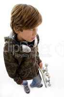 top view of child with skate and headphone