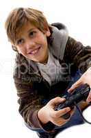 side view of amused boy playing videogame