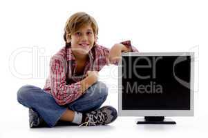 front view of sitting boy with lcd screen