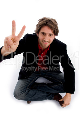 sitting man showing peace sign